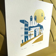 Load image into Gallery viewer, Modern minimal art print of Lake Avenue, Canal Park MN. Blue &amp; gold ink. titled, numbered and signed. Side view showing shimmering sun &amp; gold ink
